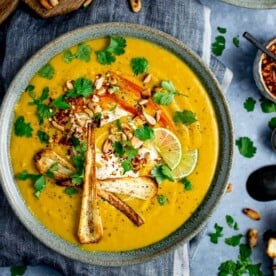 Spicy parsnip and sweet potato soup with parsnip crisps and coriander toppings