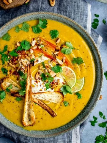 Spicy parsnip and sweet potato soup with parsnip crisps and coriander toppings