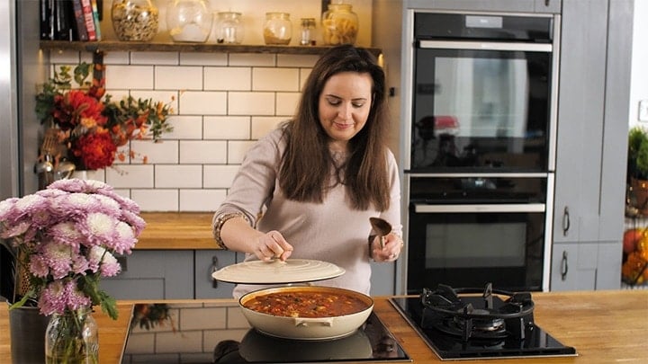 Placing a lid on a pan of jambalaya