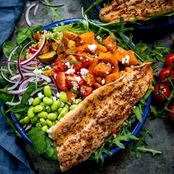 Salad bowl filled with roasted veg, tomatoes, edamame, red onion, courgette and topped with honey mustard trout.