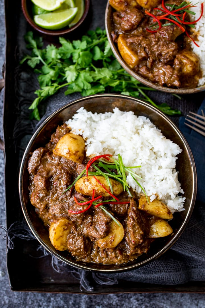 Overhead photo of Slow Cooked Beef Massaman Curry in a bowl served with Rice topped with thin strips of chilli