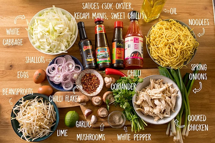 Ingredients for mee goreng on a wooden table