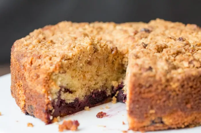 Close up of a Cherry Crumble Cake with a slice taken out