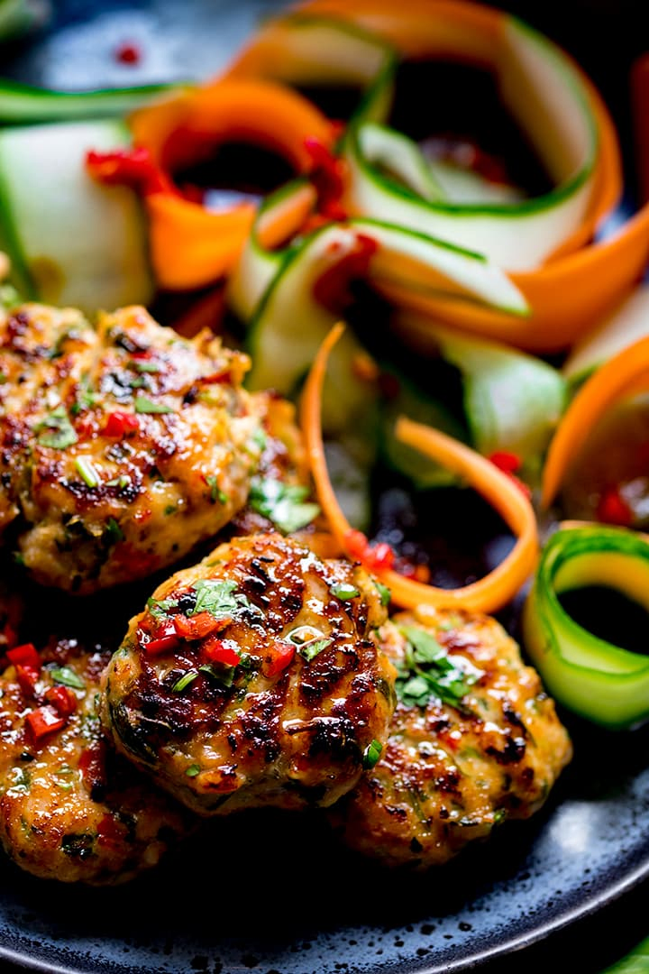 Close up of Thai salmon fishcakes on a dark plate