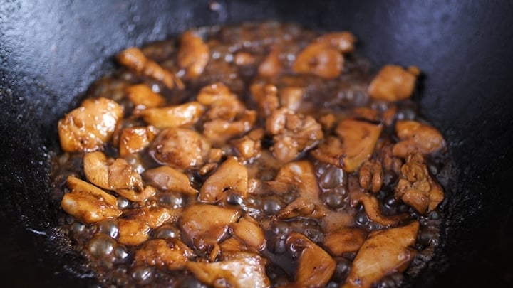 Marinated chicken cooking in a wok