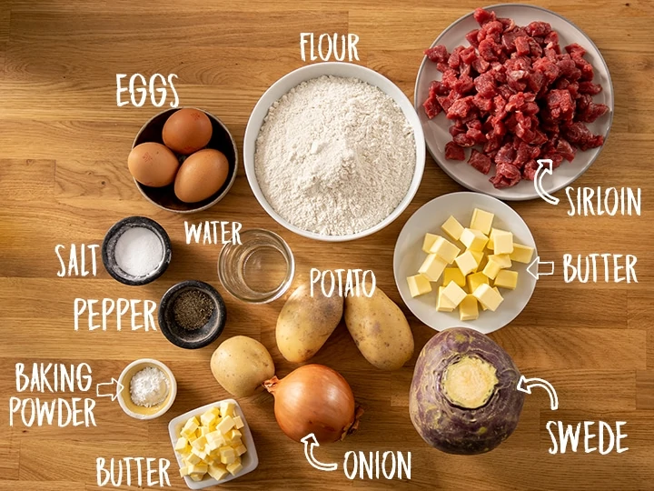 Ingredients for Cornish pasties on a wooden table