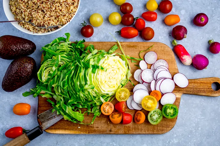 Chopped up ingredients on a board for broadbean and quinoa caprese salad