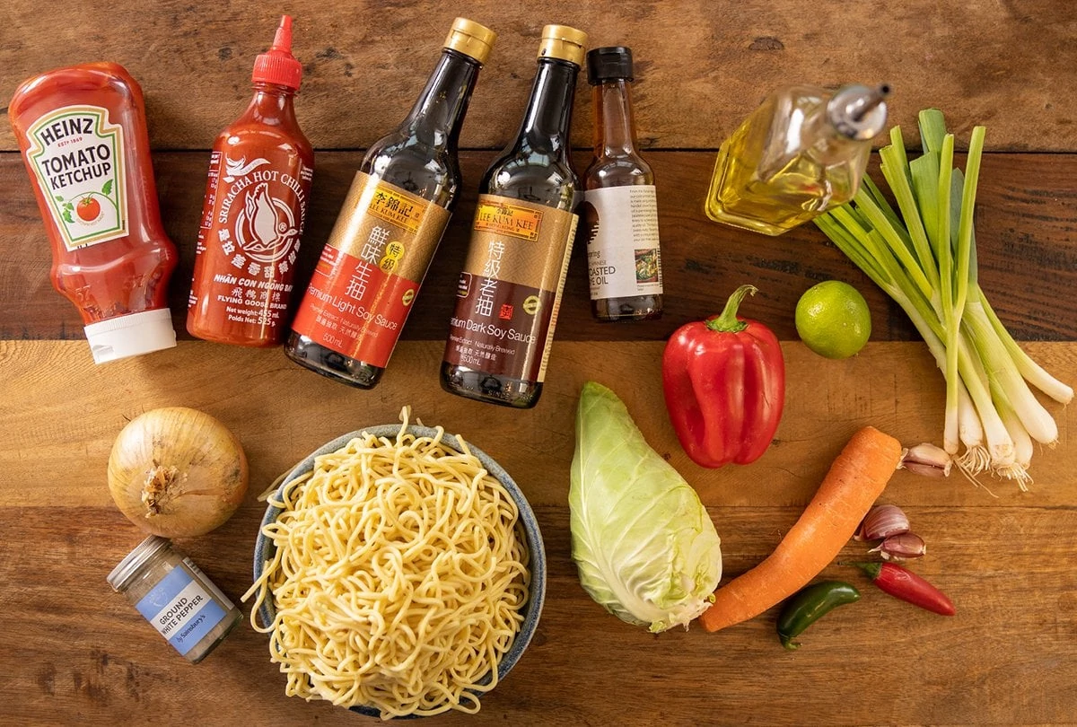 Ingredients for chilli lime noodles on a wooden table.