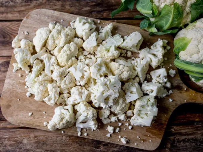 Chopped cauliflower on a chopping board