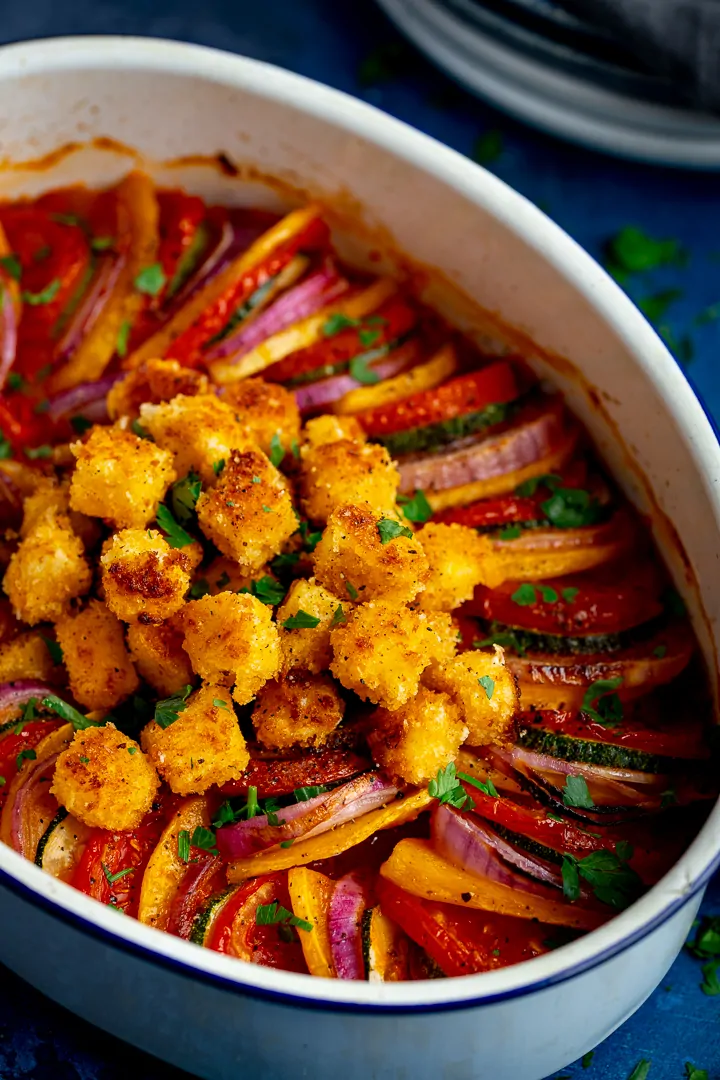 ratatouille with crispy feta croutons in a white baking dish