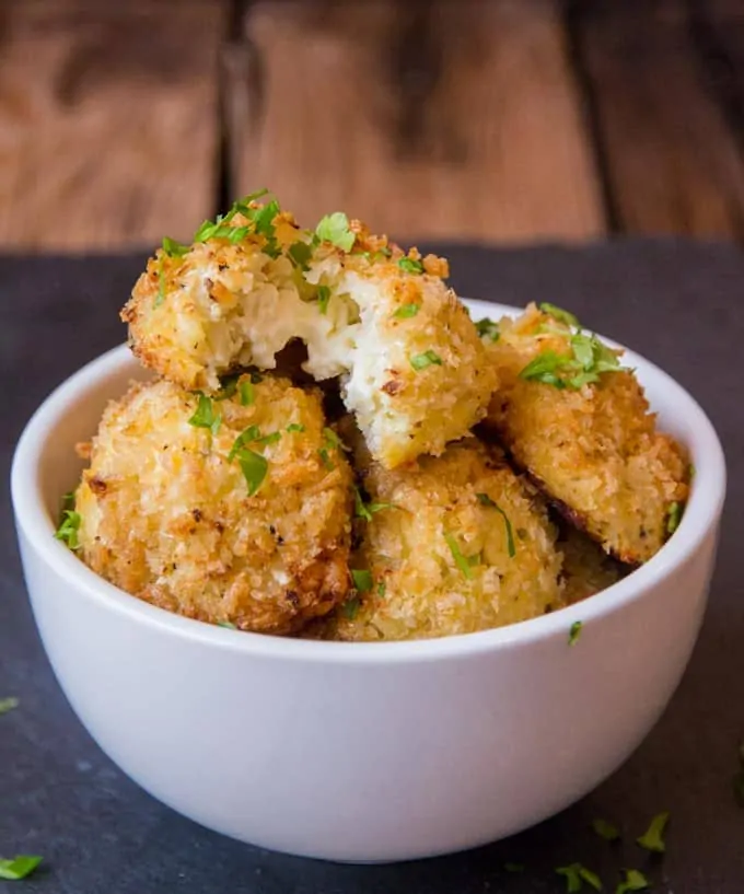 Cauliflower Arancini filled with creamy boursin cheese. Quicker and healthier than regular arancini. Baked rather than fried.