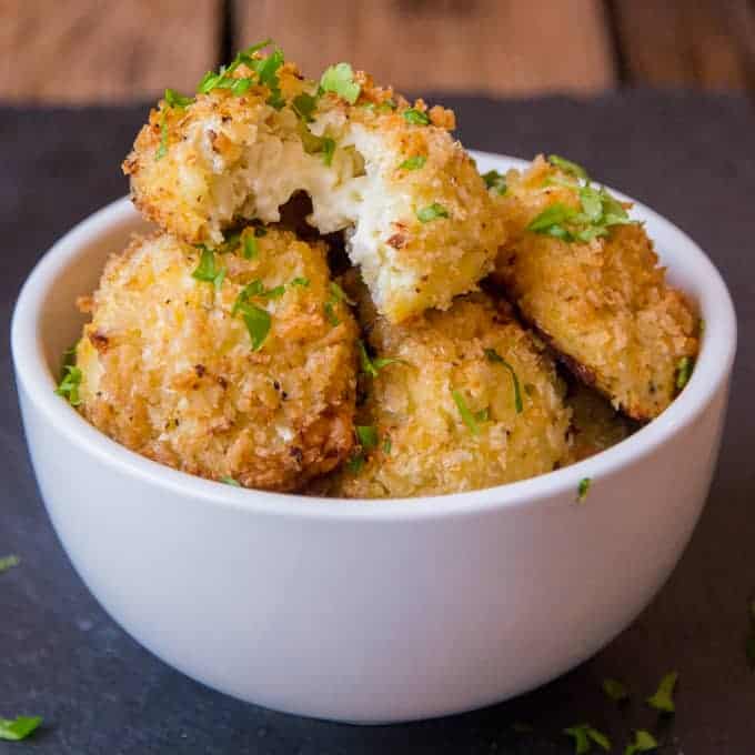 Cauliflower Arancini filled with creamy boursin cheese. Quicker and healthier than regular arancini. Baked rather than fried.