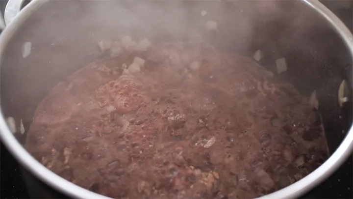 Minced beef, onions, garlic and red wine simmering in a pan