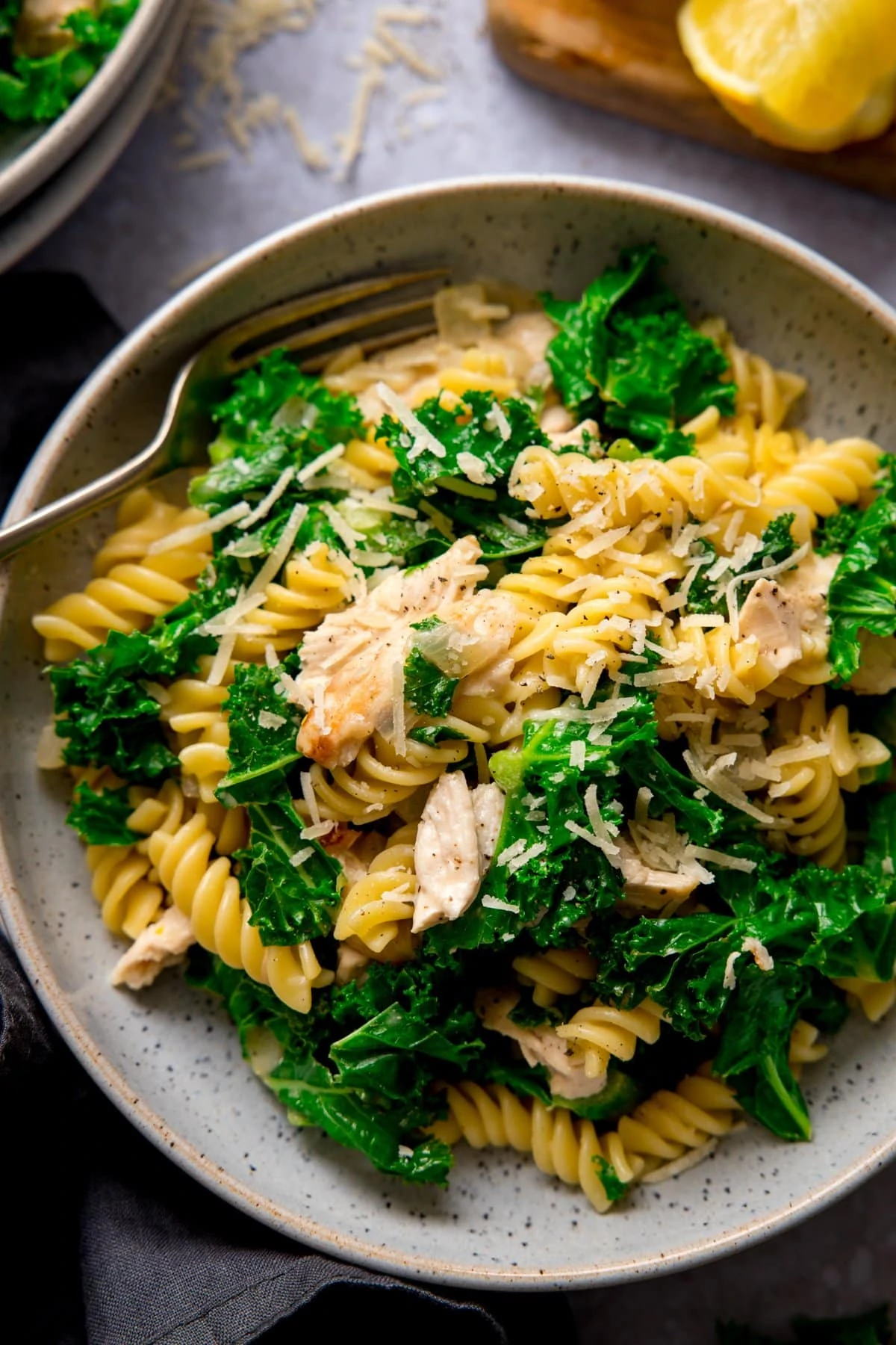 Overhead shot of a bowl of garlic chicken pasta and kale
