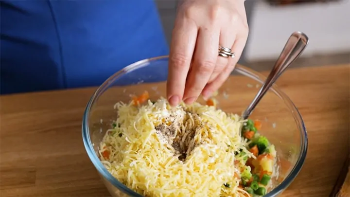 Adding cheese seasoning and cream to veggie burger filling