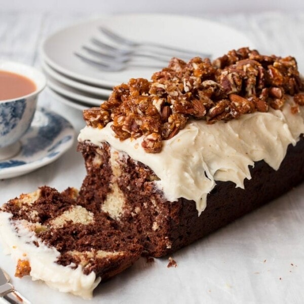 Chocolate almond banana bread - Rich and moist chocolate banana bread, dotted with swirls of frangipane and topped with almond frosting and candied nuts.