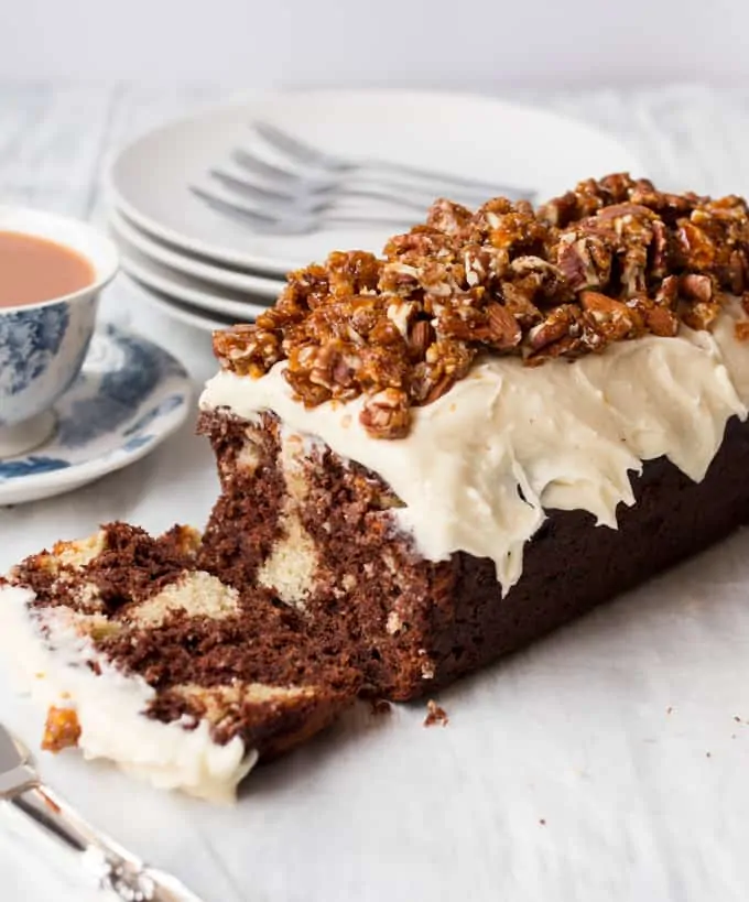 Chocolate almond banana bread - Rich and moist chocolate banana bread, dotted with swirls of frangipane and topped with almond frosting and candied nuts.