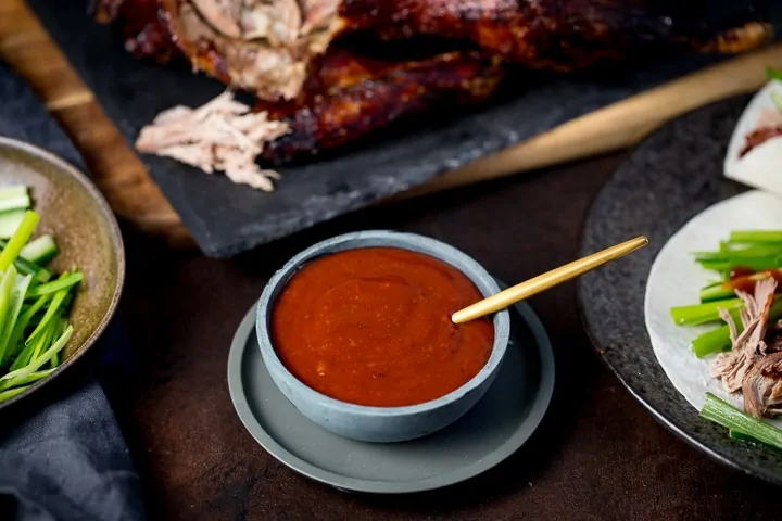 grey bowl filled with plum sauce for duck