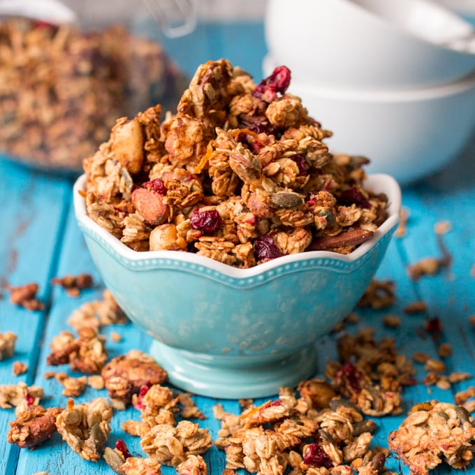 A blue bowl brimmed full of Cranberry nut granola