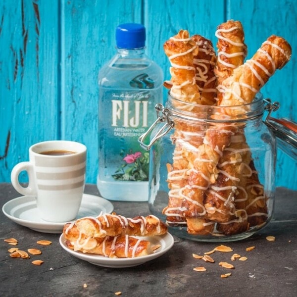 Croissant twists - flaky croissant pastry, filled with almond paste and drizzled with creamy almond frosting.