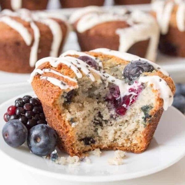 Light and fluffy berry muffins, packed with berries and topped with a vanilla and chia seed drizzle. Gluten Free - but you couldn't tell.