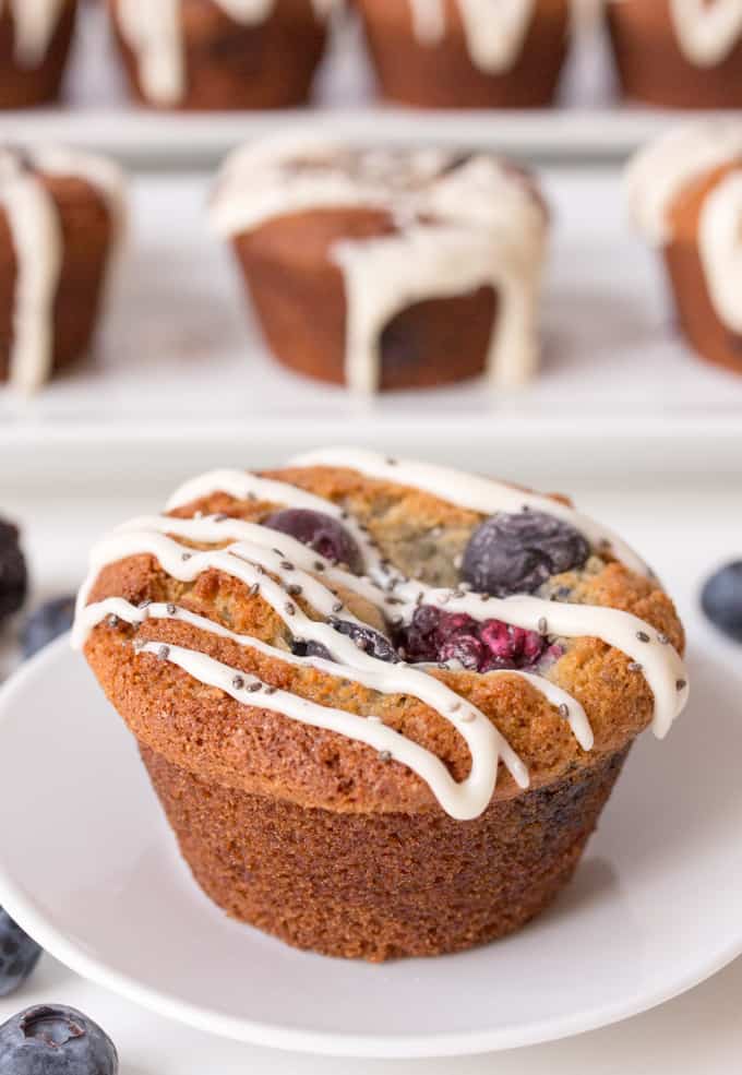 Light and fluffy berry muffins, packed with berries and topped with a vanilla and chia seed drizzle. Gluten Free - but you couldn't tell.