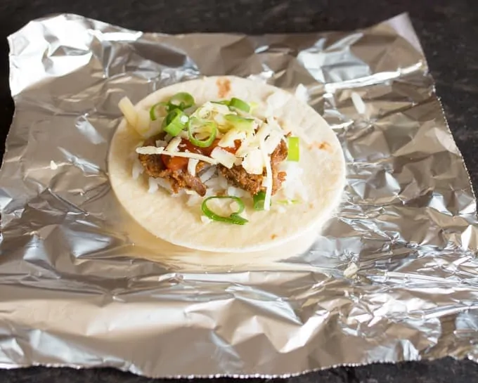 mini burritos - A great make-ahead appetizer for parties. Prepare, wrap in foil and then reheat for 10 minutes in the oven before serving with some sour cream.