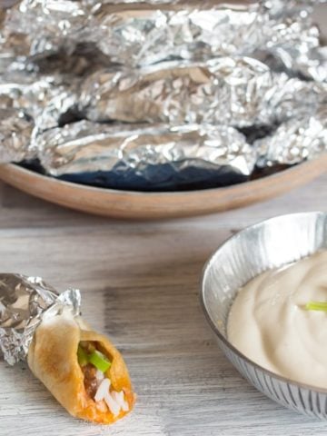 Mini burritos - A great make-ahead appetizer for parties. Prepare, wrap in foil and then reheat for 10 minutes in the oven before serving with some sour cream.