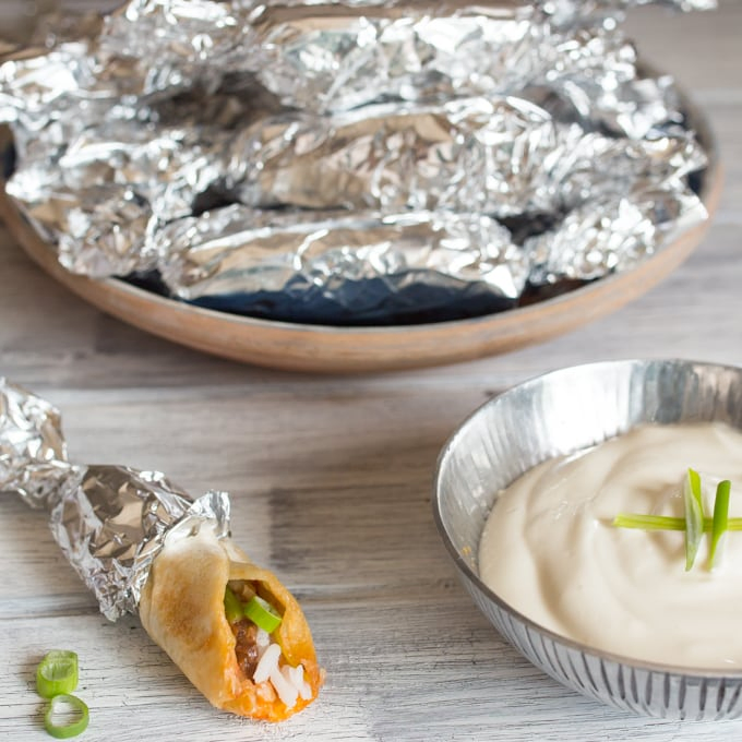 Mini burritos - A great make-ahead appetizer for parties. Prepare, wrap in foil and then reheat for 10 minutes in the oven before serving with some sour cream.