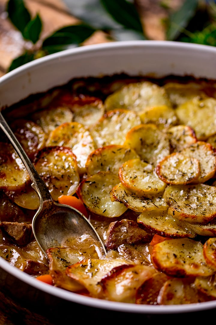 Close up of spoonful being taken from Lancashire hotpot 