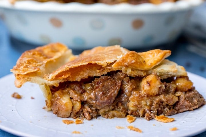 Wide image of slice of steak and potato pie