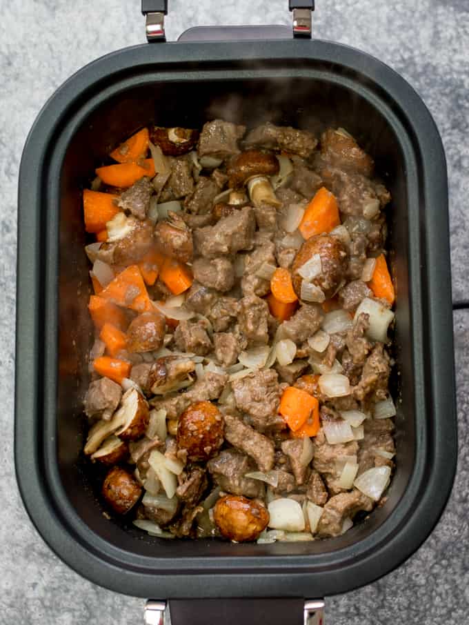 Seared beef, onions carrots and mushrooms in a crockpot