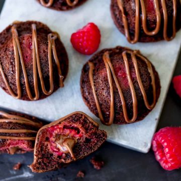 Bitesize chocolate cakes with fresh raspberry and Nutella centre, drizzled with Nutella.
