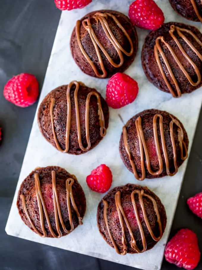Mini chocolate cakes with raspberry and Nutella centre, drizzled with Nutella.