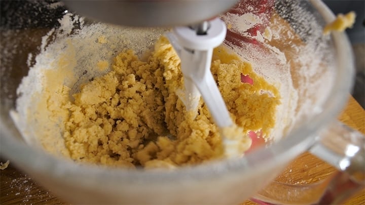 Butter and sugar being mixed in a stand mixture