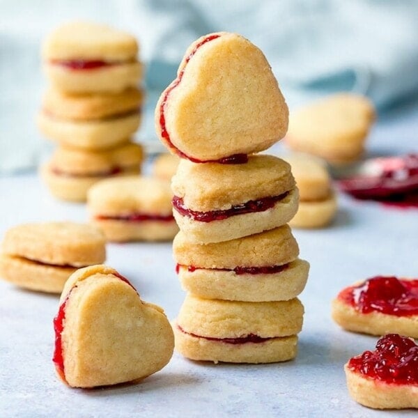 Stack of heart shaped valentine shortbread cookies on a light blue background