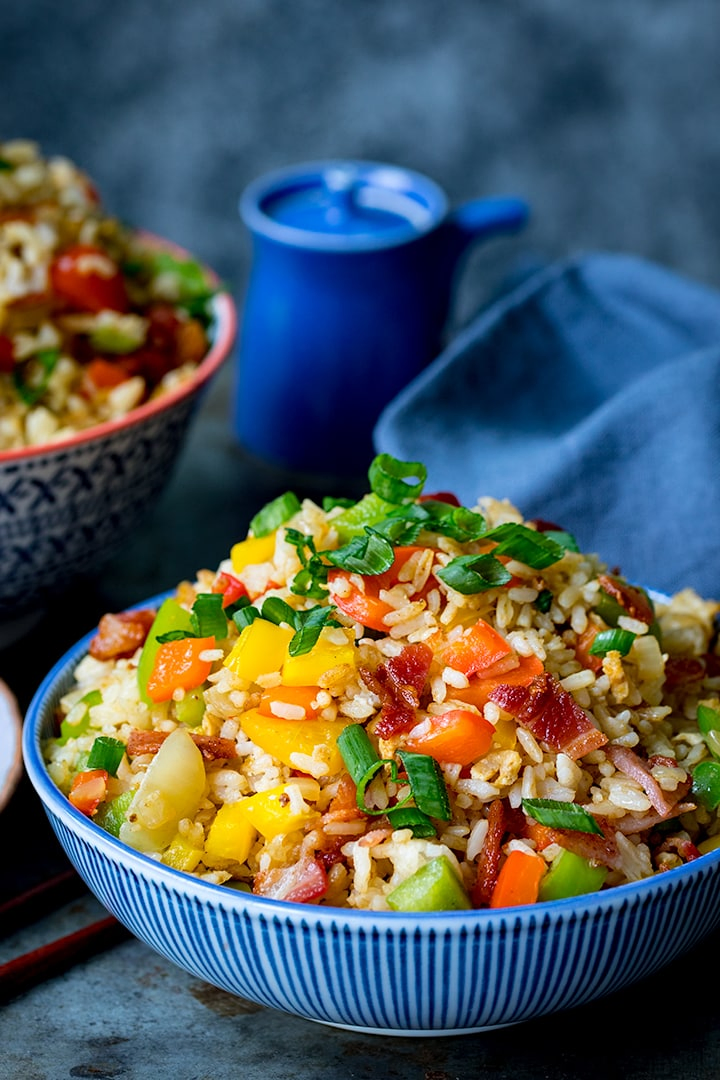 Fried rice in a blue bowl with blue background