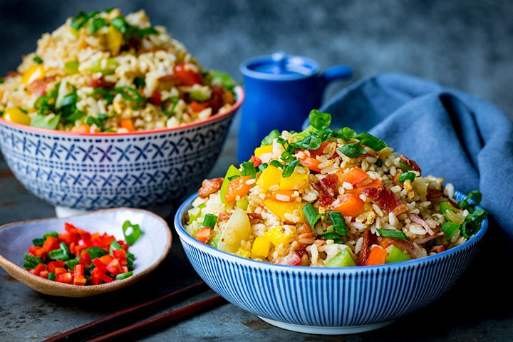 Two bowls of fried rice and a small dish of chopped chillies