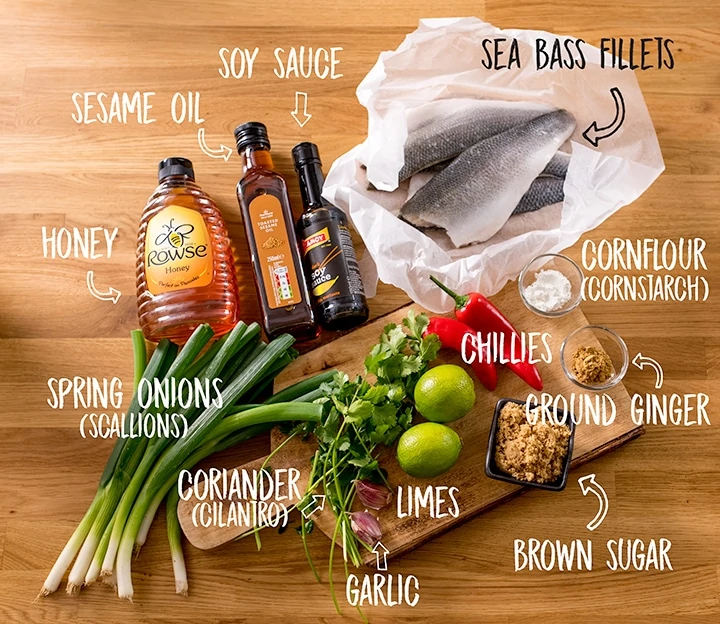 Ingredients for sticky Asian sea bass on a wooden table