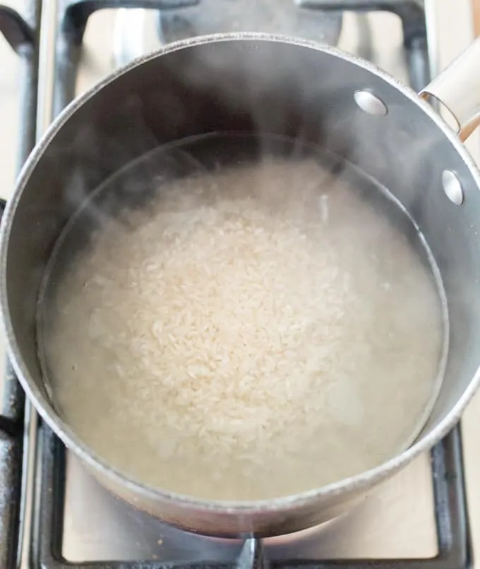 Long grain rice in a pan of boiling water