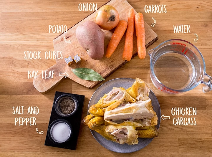 Ingredients for chicken soup on a wooden background