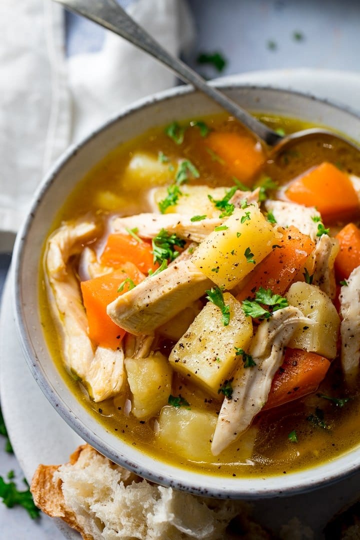 Close up of a bowl of chicken and vegetable soup