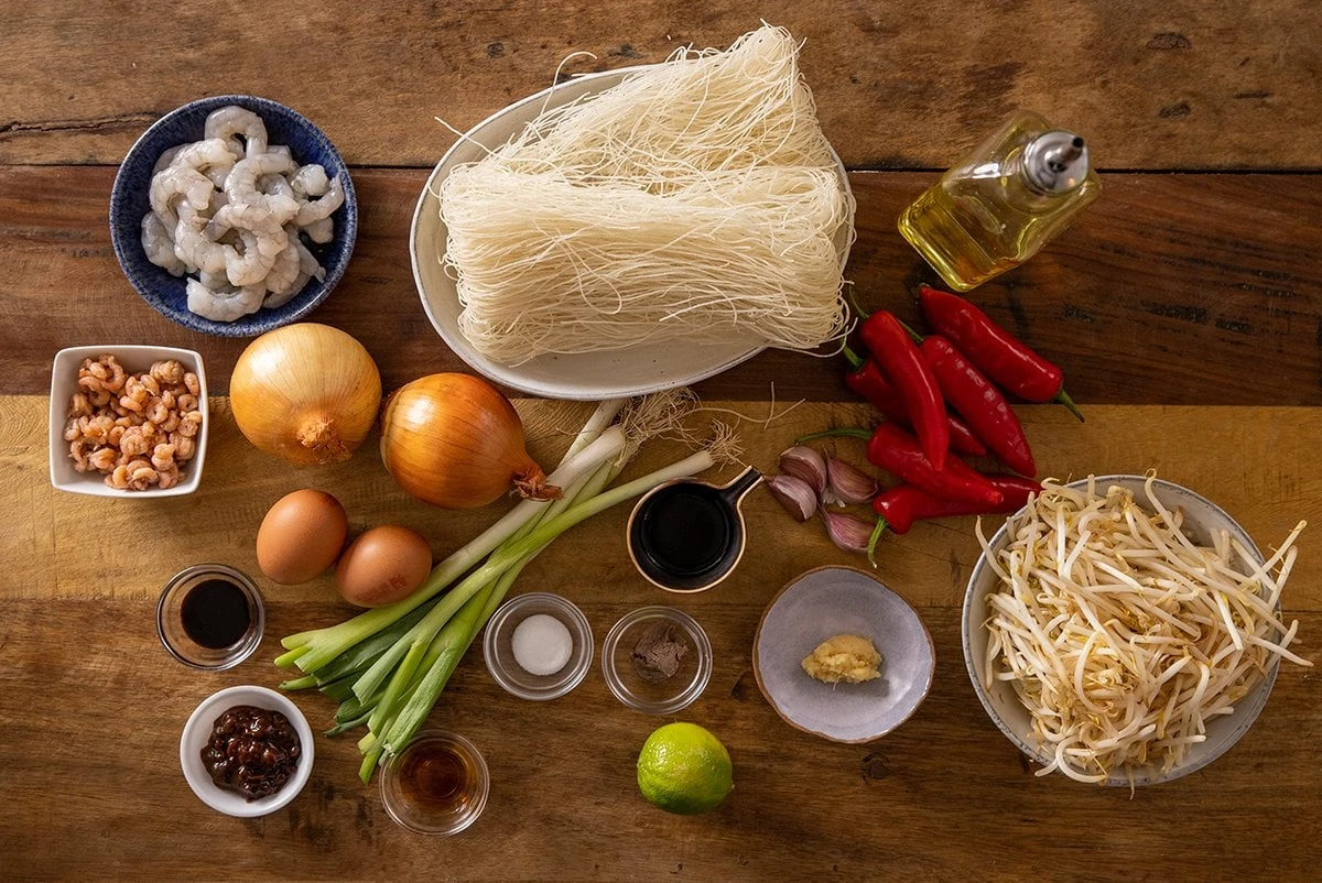 Ingredients for Mee Siam on a wooden table.