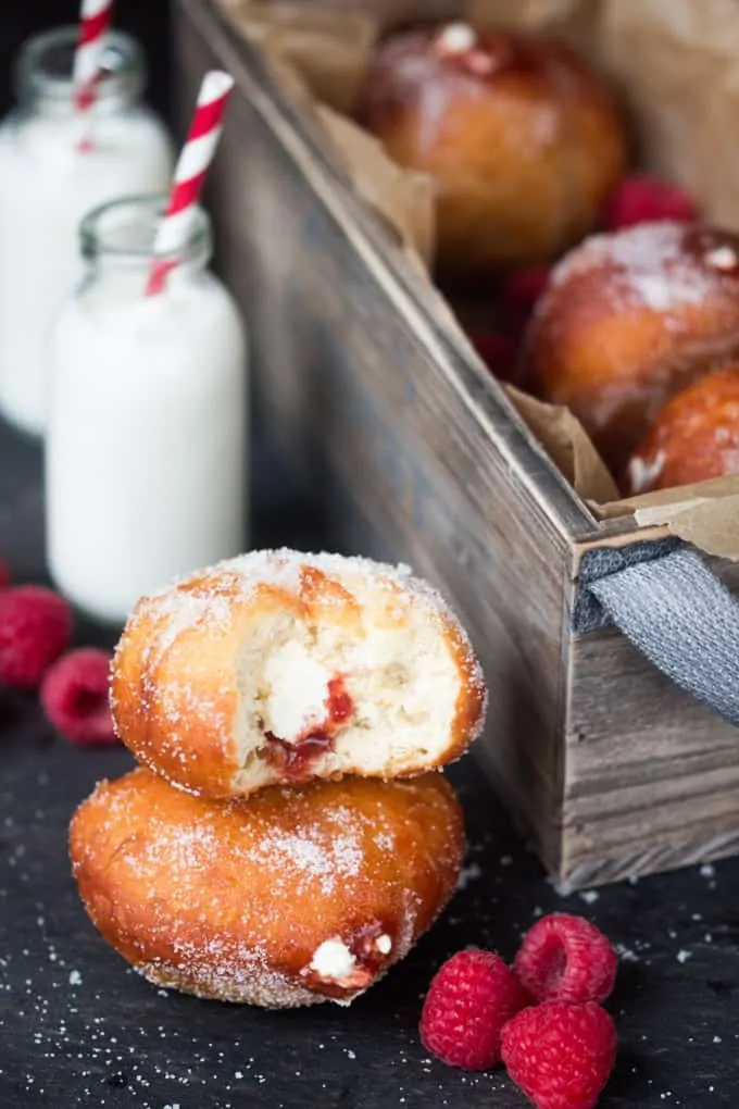Raspberry Ripple Doughnuts - Golden brown, sugar dusted and served slightly warm - filled with raspberry jam and sweetened cream. Irresistible!