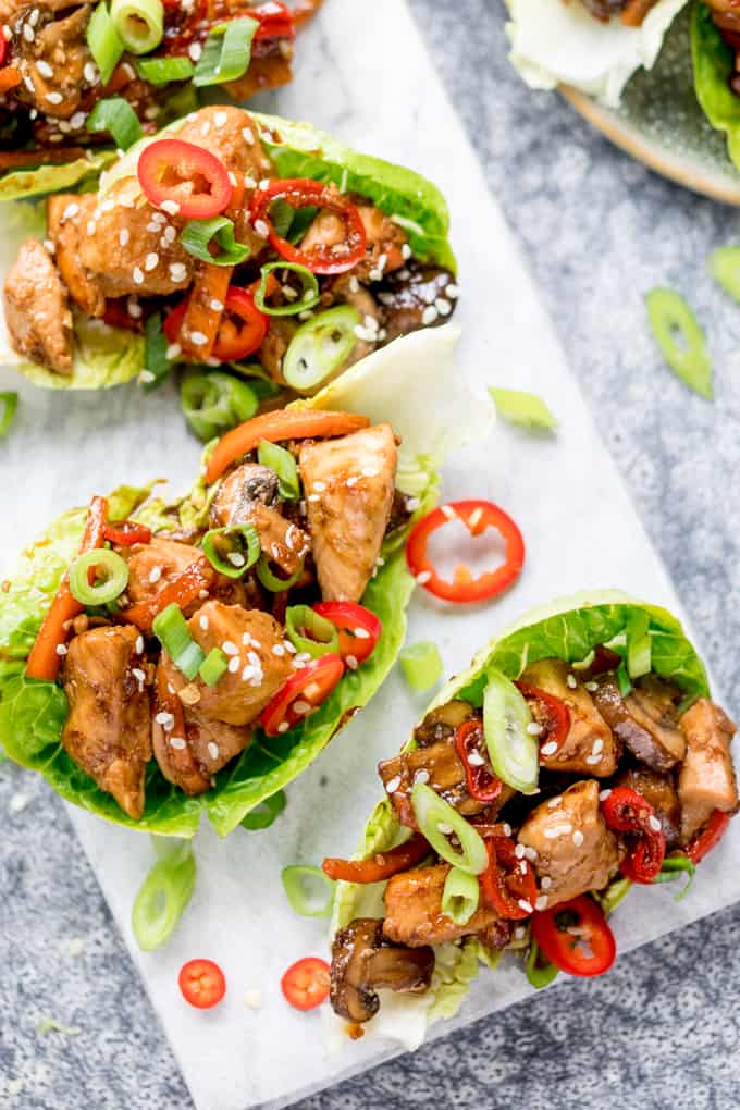 Overhead image of lettuce wraps filled with asian chicken