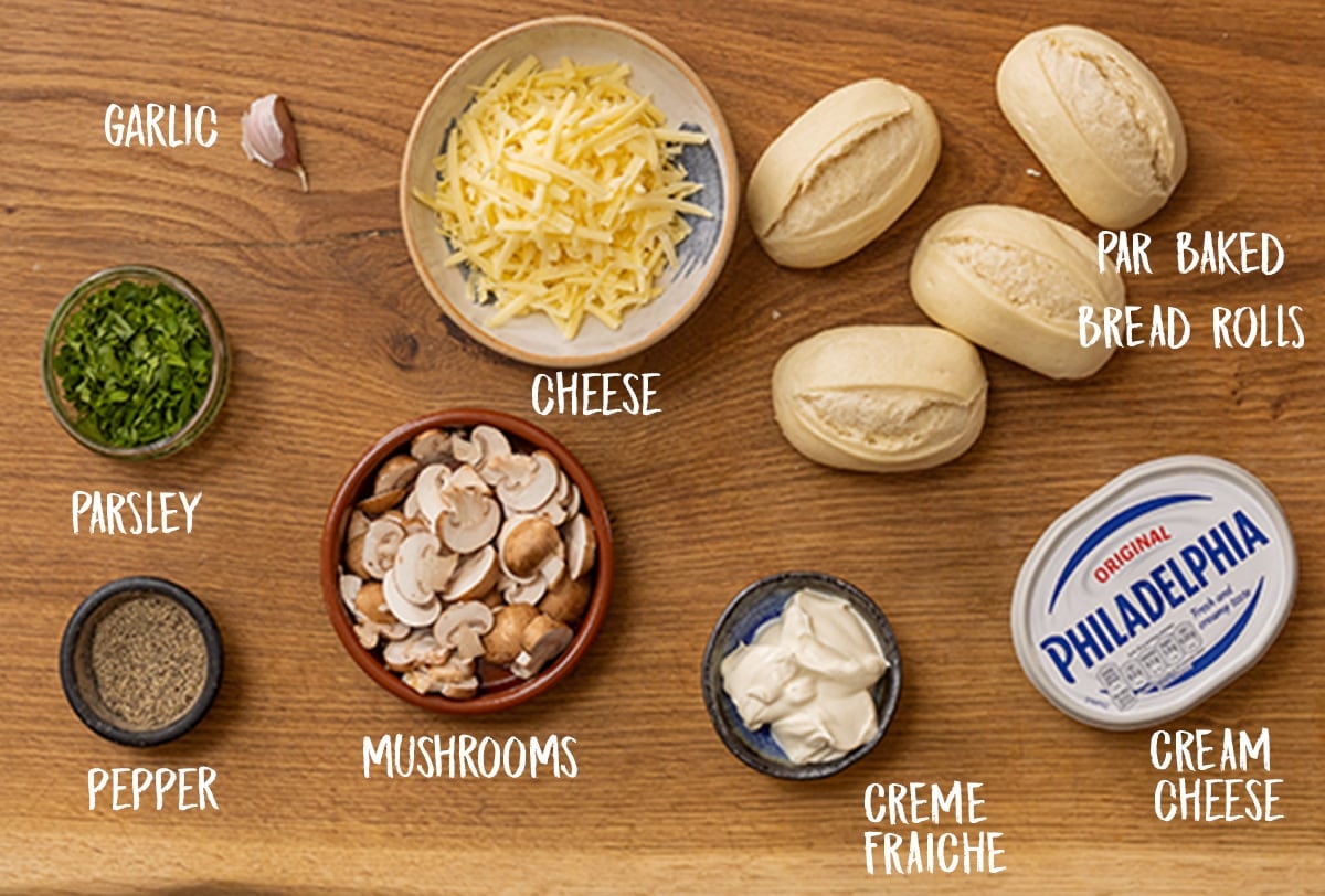 Ingredients for Cheesy Mushroom Stuffed Garlic Breads on wooden background.