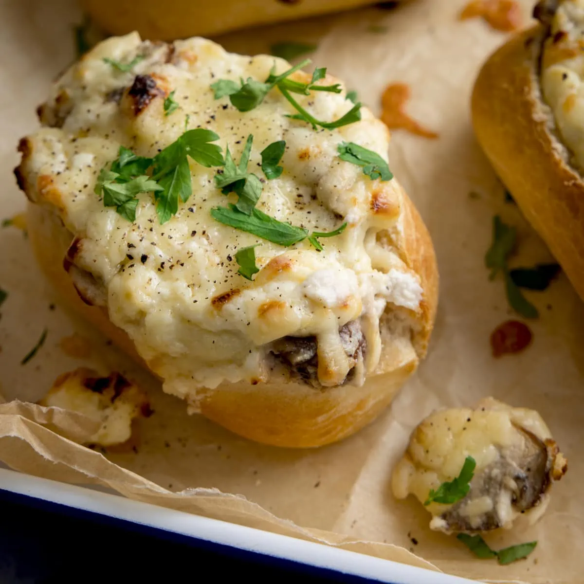 Square close up image of Cheesy Mushroom Stuffed Garlic Breads topped with parsley.