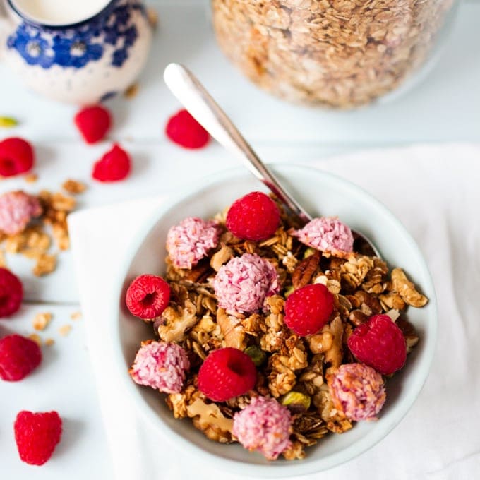 Crunchy, coconut oil granola topped with super-quick, fresh raspberry macaroons.