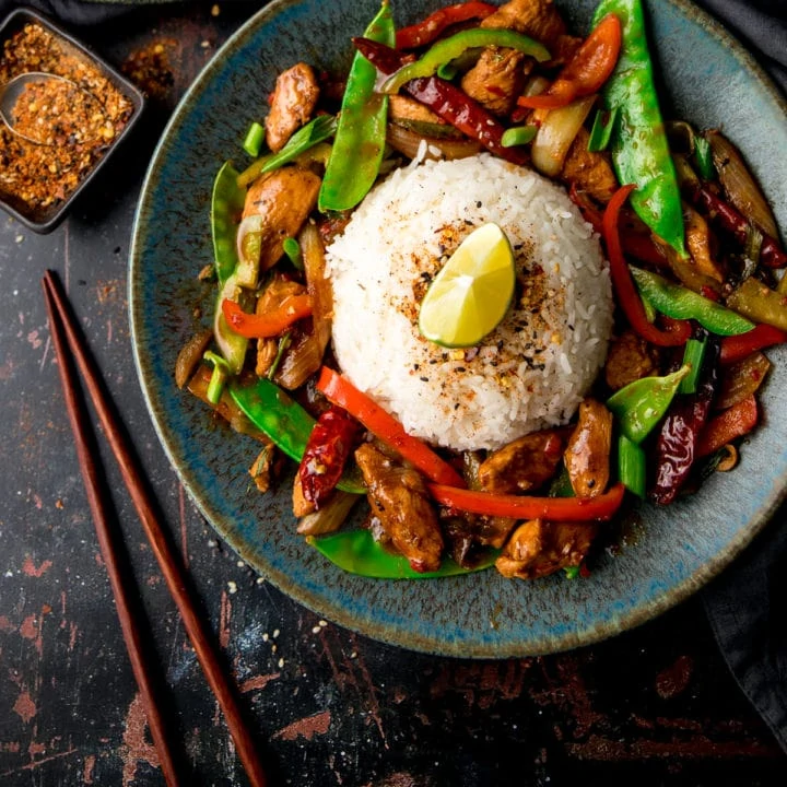 Firecracker Chicken on a blue plate against a dark background