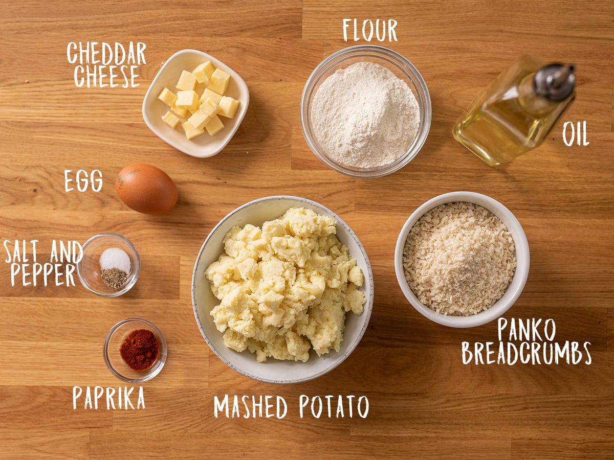 Ingredients for potato croquettes on a wooden table